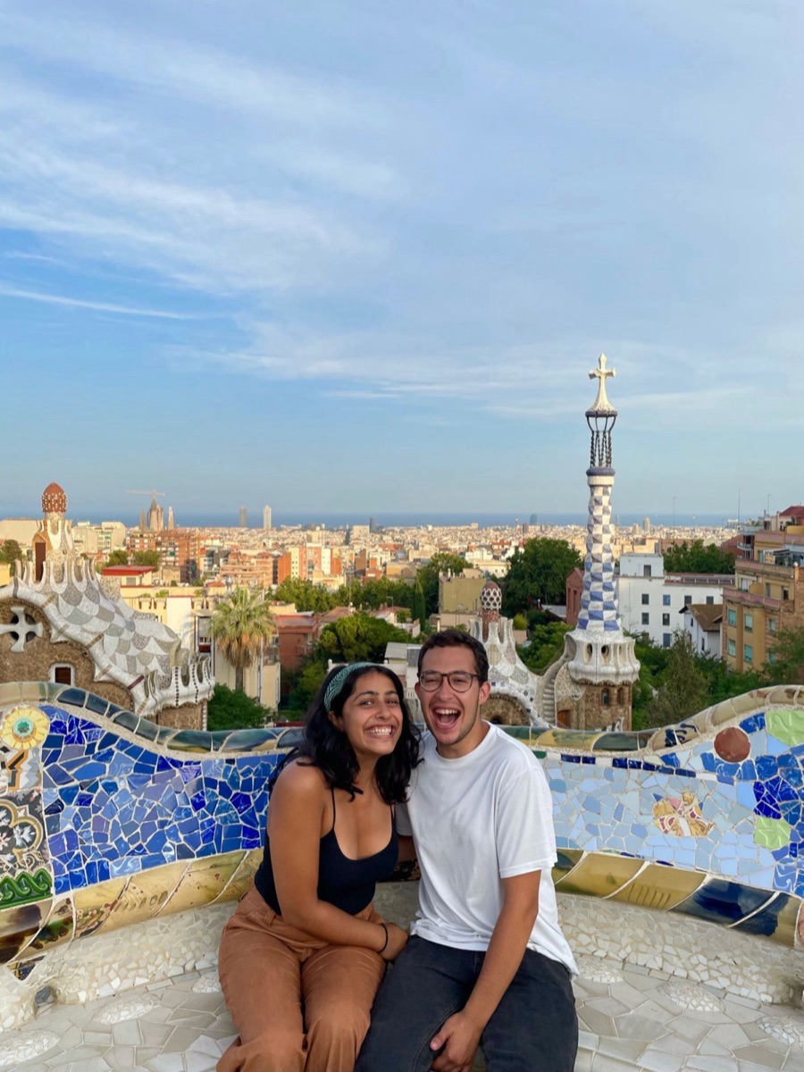 Tanya and Marcos laughing on a mosaic bench